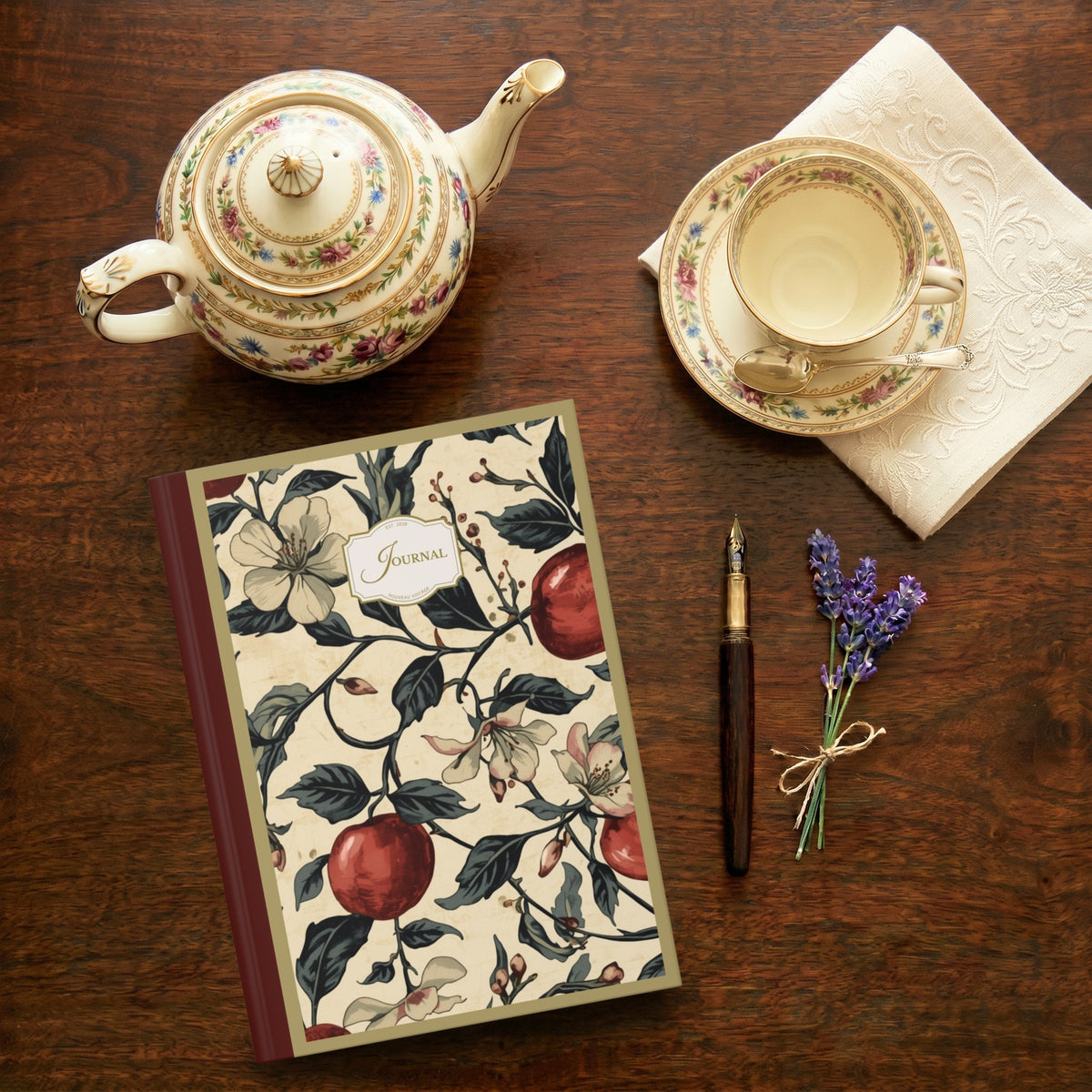 Tea set with teapot, cup, and saucer on a wooden table with a decorative journal, fountain pen, and lavender sprig.