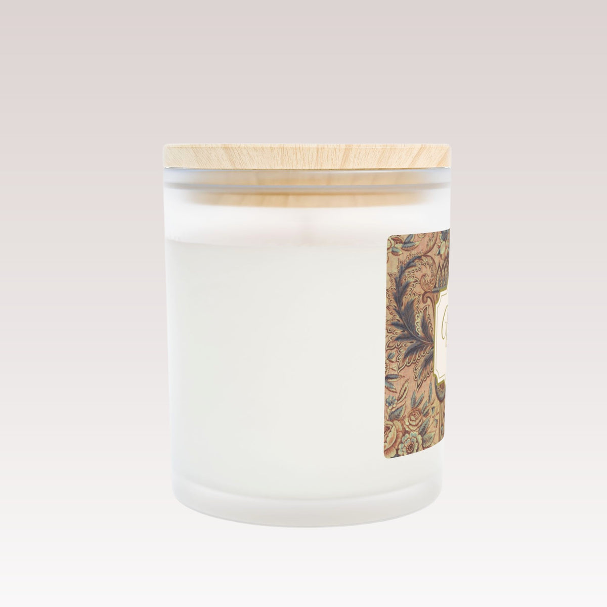 A close-up side view of a white candle in a frosted glass jar with a wooden lid.