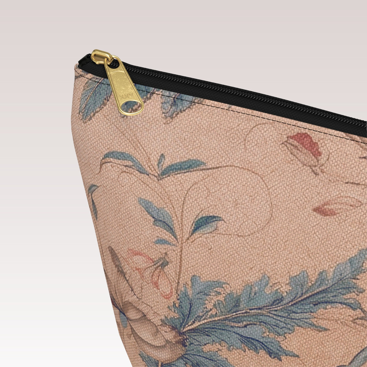 Decorative toiletry bag with a black zipper and a gold-tone zipper pull.